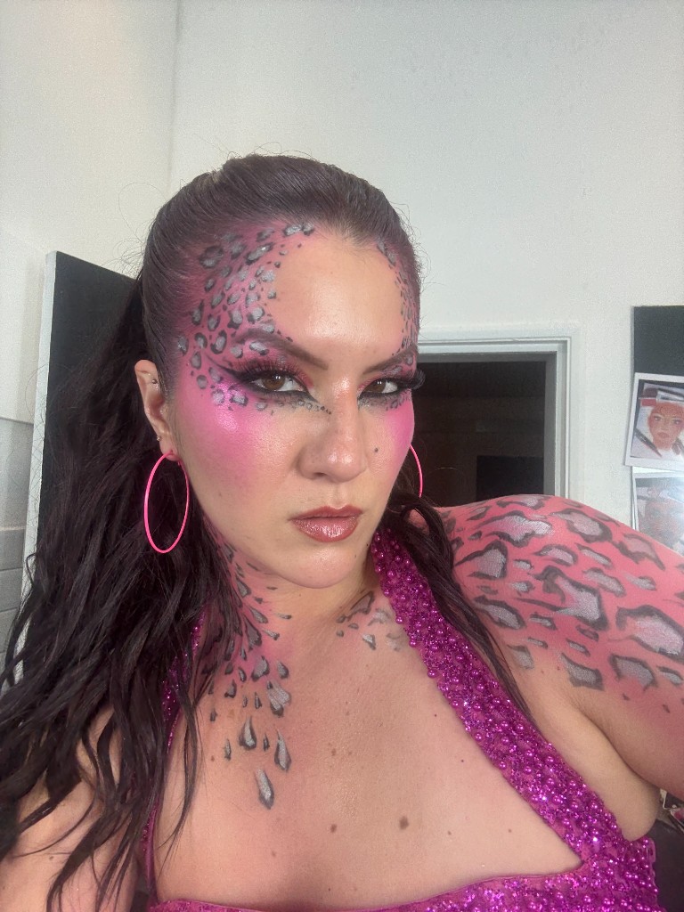 Pink leopard print painted across the face and shoulder