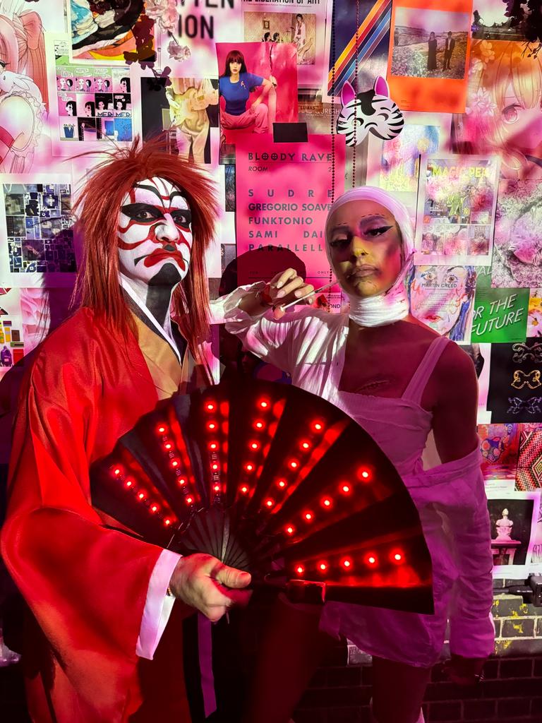 Two character looks with a lit fan