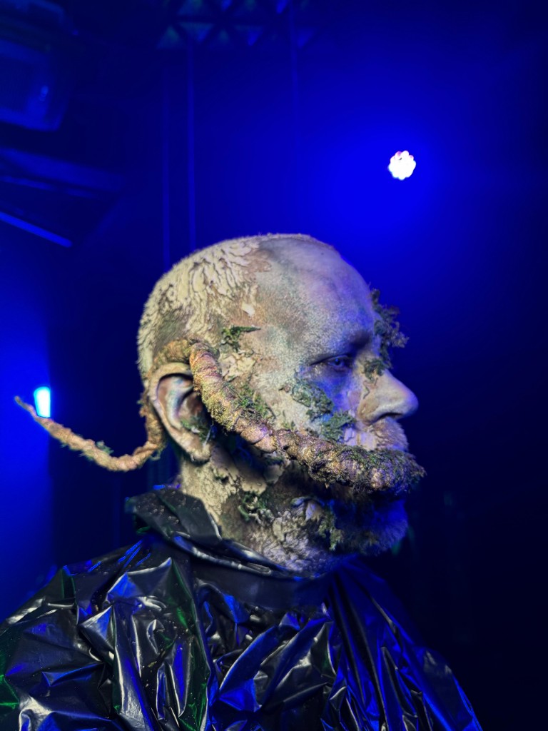Horned prosthetic in blue stage light