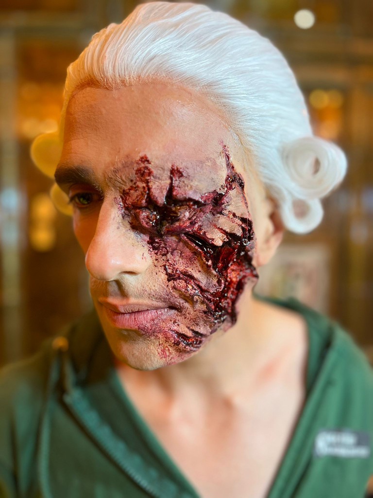 White wig with a sculpted facial prosthetic